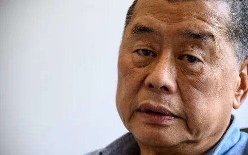 Close-up of an older East Asian man with short dark hair, looking thoughtful.