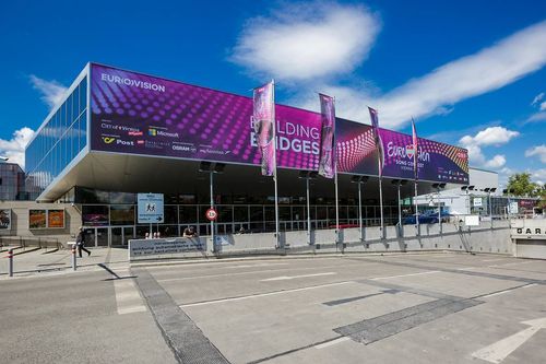 Modern building with large digital banner for the EUROBIM conference, displaying 'BUILDING BRIDGES'.