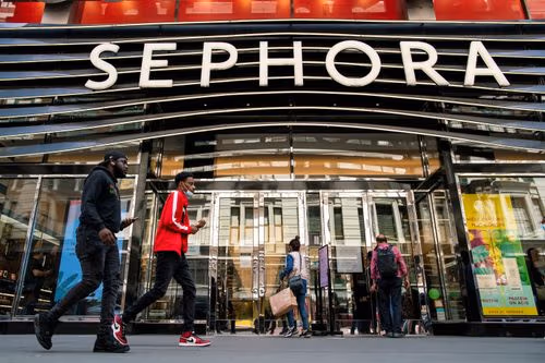 The front facade of a Sephora store with its prominent logo and people walking by.