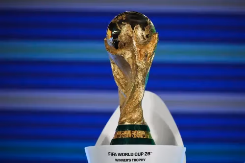 The iconic golden FIFA World Cup trophy displayed on a white stand.